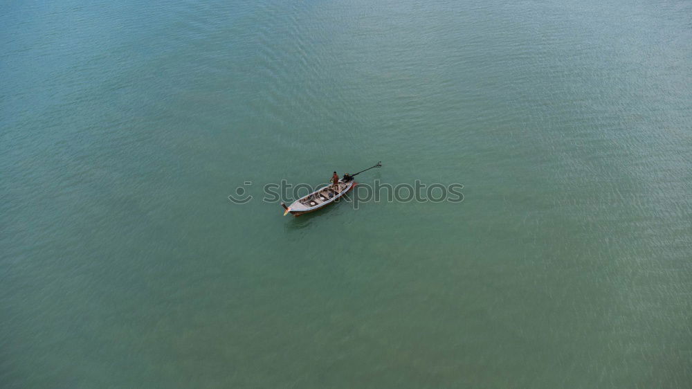 Similar – Image, Stock Photo In gliding flight a seagull flies in the upwind over the Pacific.  It can be seen alone in the picture. On the lower right. Otherwise only water is visible.