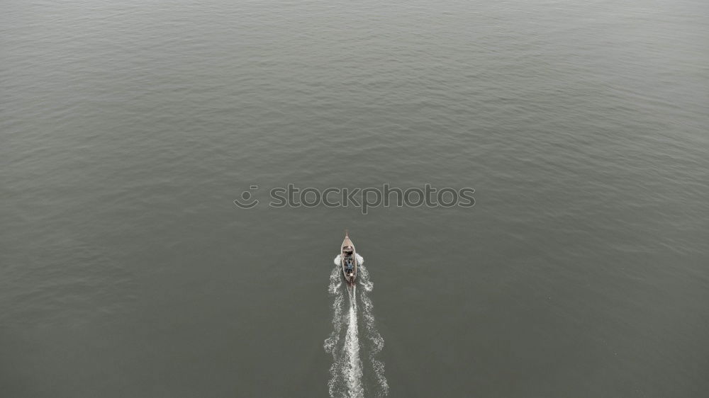 Similar – Image, Stock Photo In gliding flight a seagull flies in the upwind over the Pacific.  It can be seen alone in the picture. On the lower right. Otherwise only water is visible.