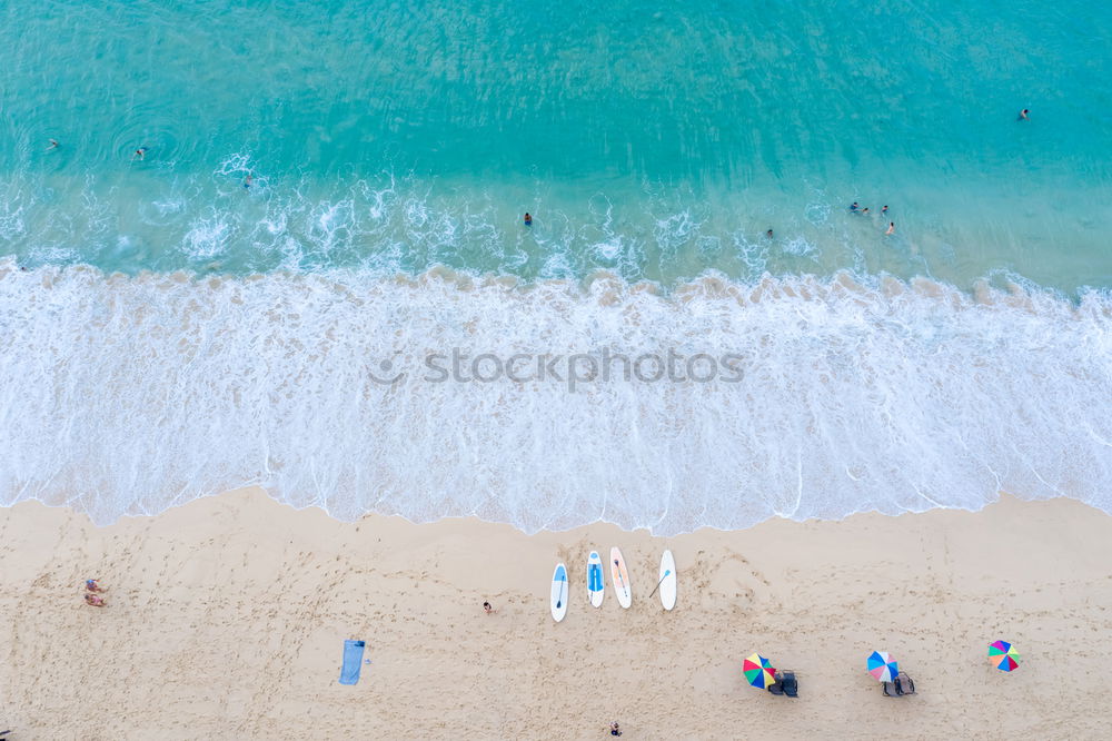 Similar – Drone shot of many people enjoying the beach and the ocean in high season- vacation pattern.