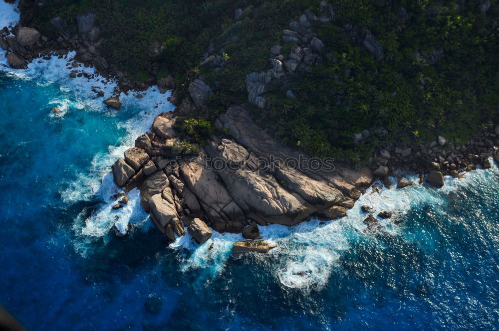 Similar – Aerial views of a coastline with waves and rocks