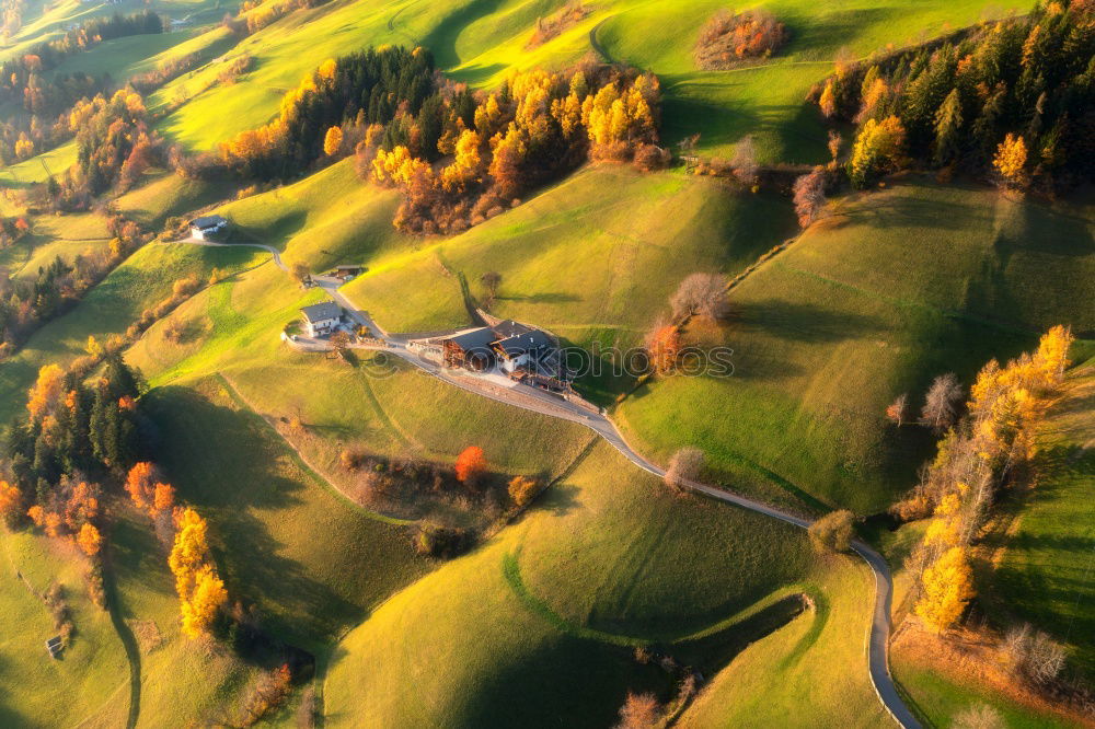 Similar – Curved serpentine road trough fall forest and village.