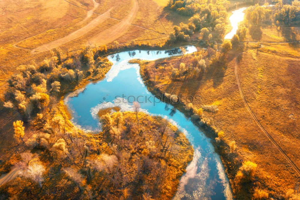 Similar – Curved road in fall forest and village.