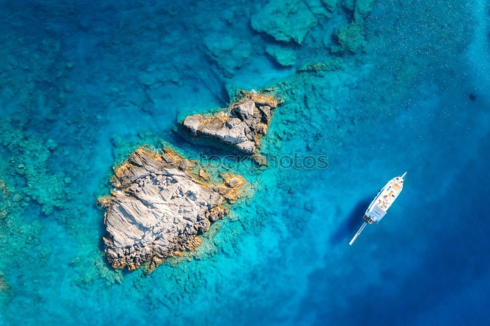 Similar – Image, Stock Photo Peninsula with rocks and beach in turquoise blue sea from above