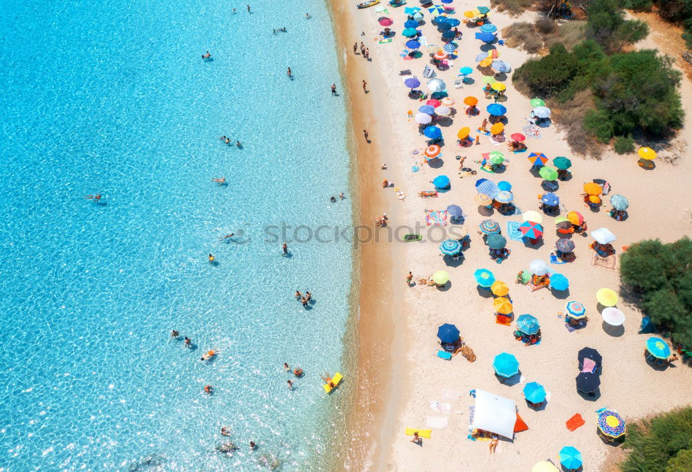 Similar – Drone shot of many people enjoying the beach and the ocean in high season- vacation pattern.