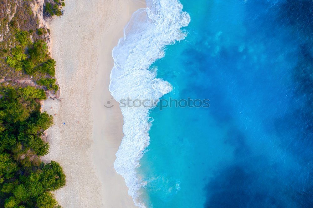 Lonely bay with white sand beach and turquoise sea from above