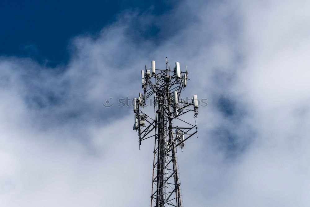 Similar – Telecommunication tower with cloudy sky background. Antenna on blue sky. Radio and satellite pole. Communication technology. Telecommunication industry. Mobile or telecom 5g network. Technology