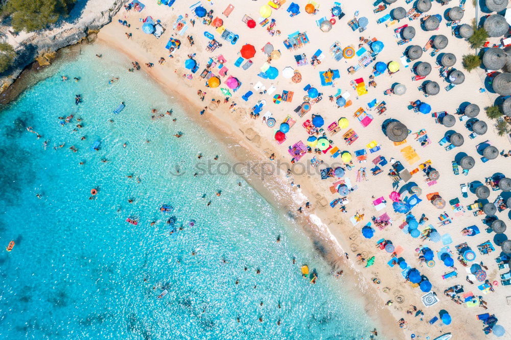 Similar – Drone shot of many people enjoying the beach and the ocean in high season- vacation pattern.