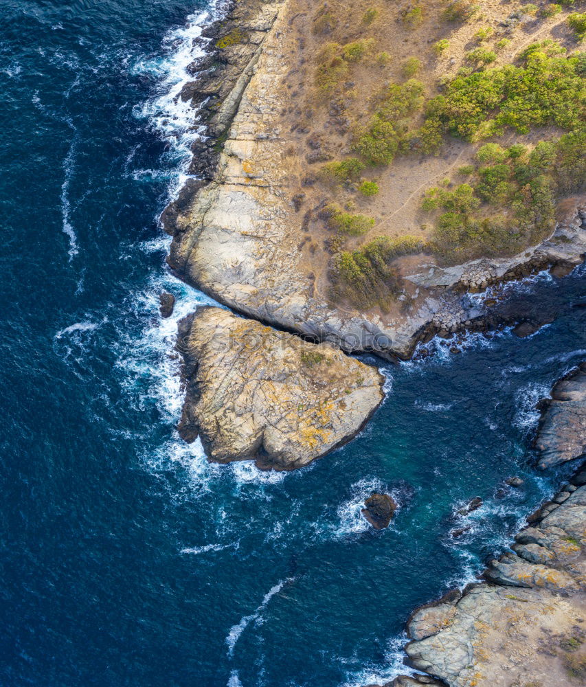 Similar – Aerial views of a coastline with waves and rocks