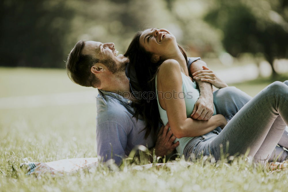 Similar – Happy smiling couple laying on green grass