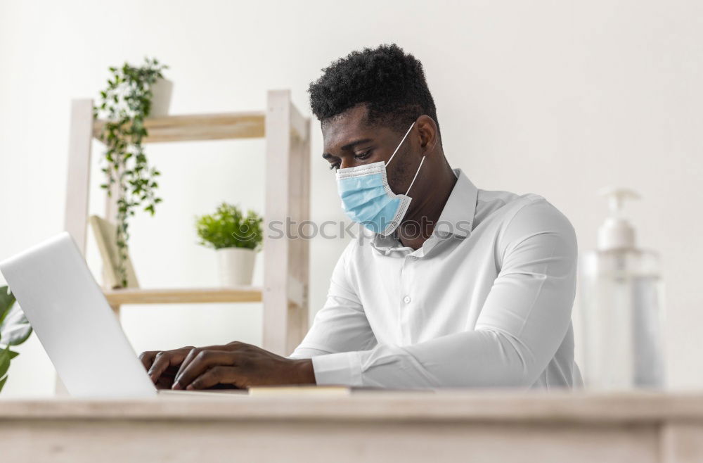 Similar – Young Businessman Wearing Mask Working On Laptop At Hot Desk In Office During Health Pandemic