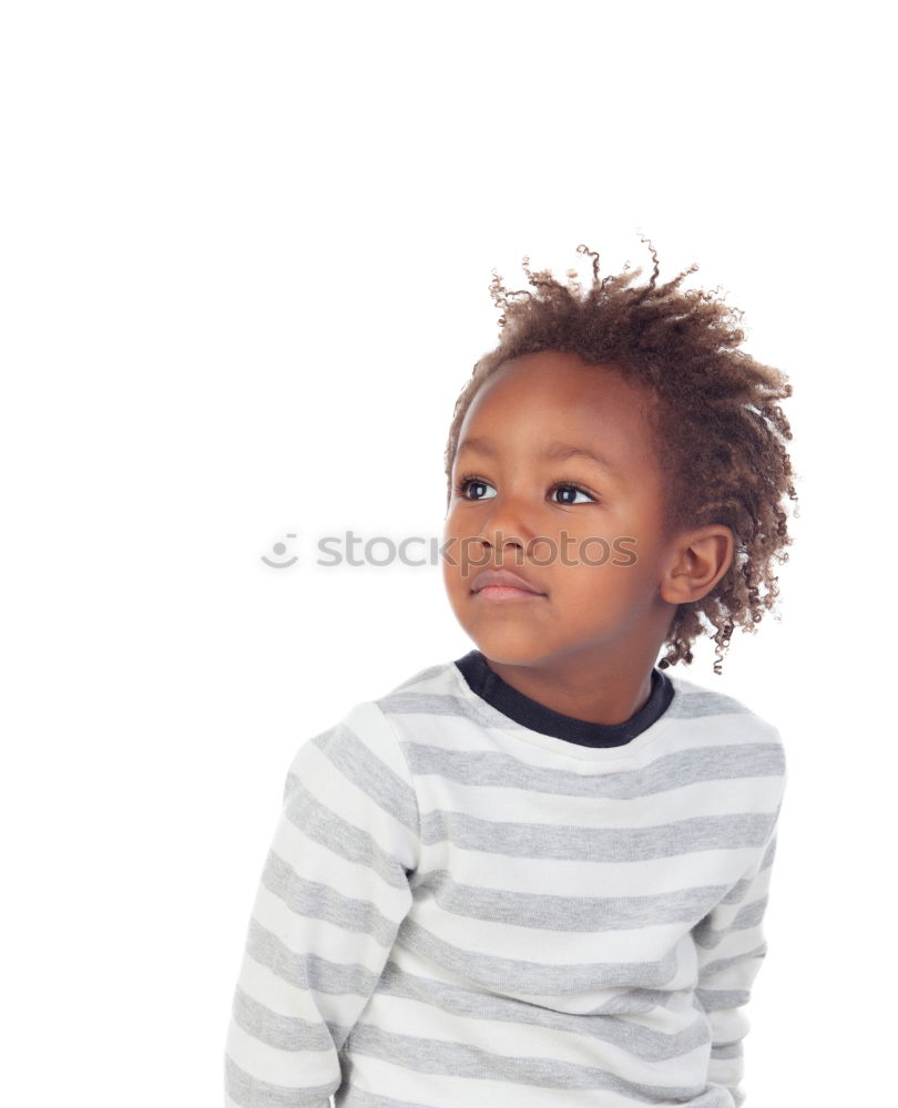 Cute male toddler laying on bed looking at camera