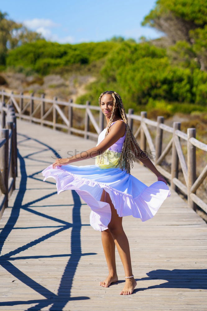 Similar – Young, very athletic woman with six pack stands barefoot on a wooden bridge in the forest and holds one leg stretched over her head