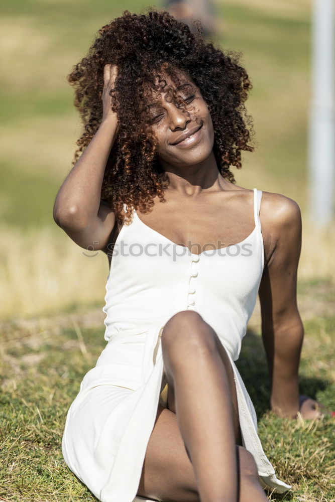 Similar – Black woman with afro hairstyle sittin on a urban bench