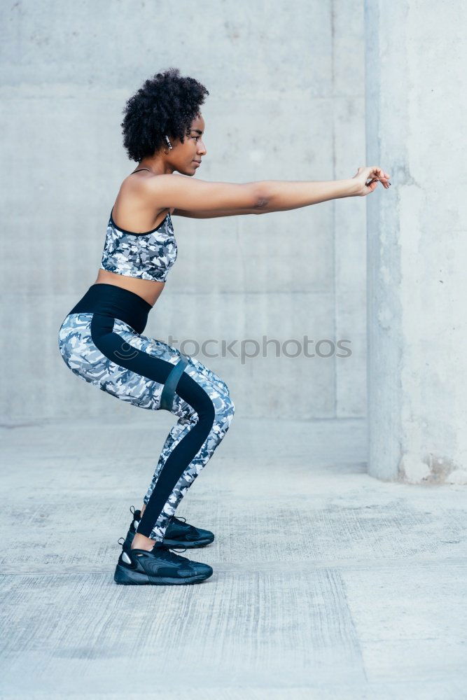 Similar – Young black woman doing stretching after running outdoors