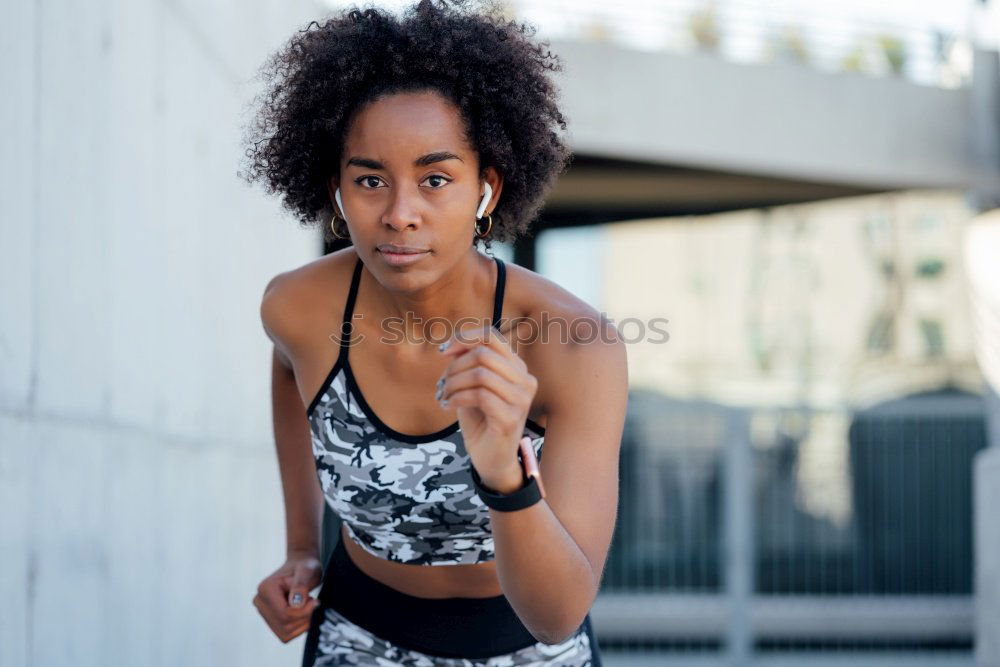 Black woman, afro hairstyle, running outdoors