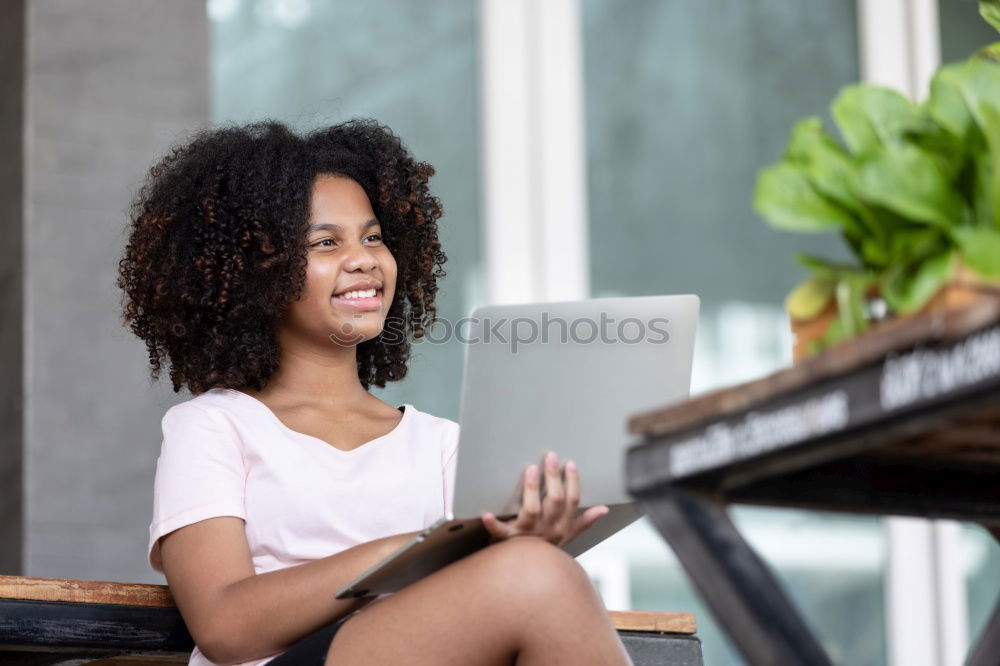 Similar – Beautiful afro american woman using mobile and laptop in the coffee shop.