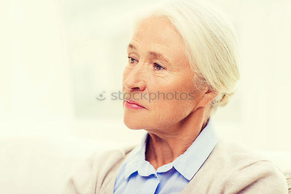 Similar – Image, Stock Photo Beautiful African woman from Togo with very short hair, slightly opened mouth, one earring with pearl in a white and pink striped fine shirt with collar from below in half profile