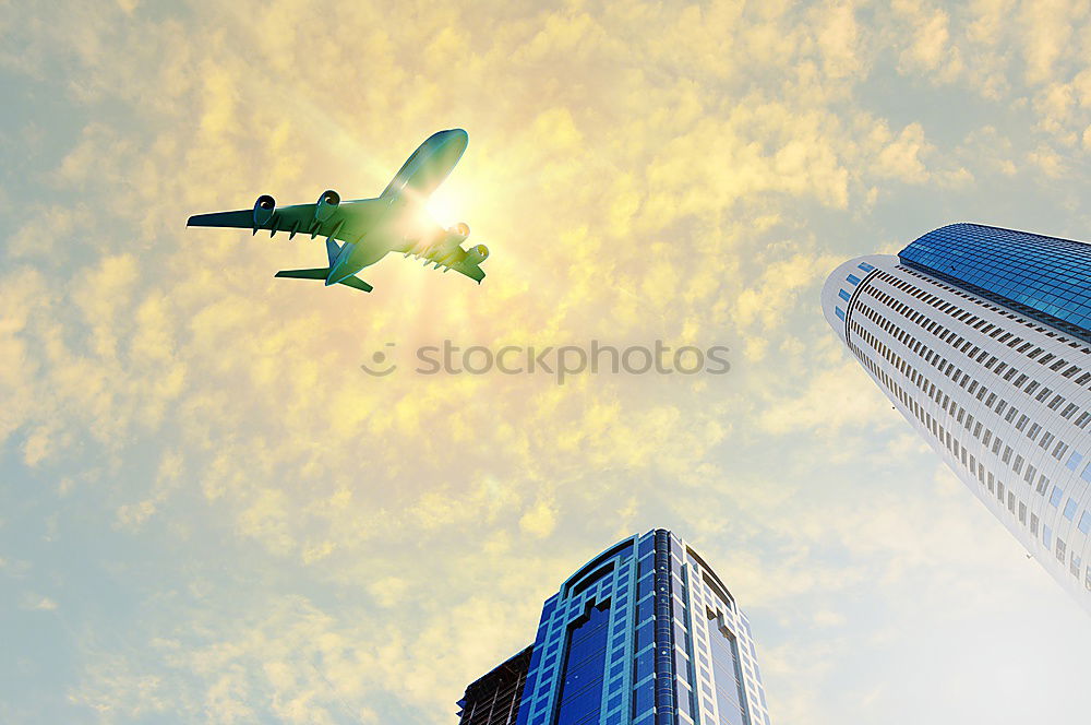 Similar – Plane flying over building