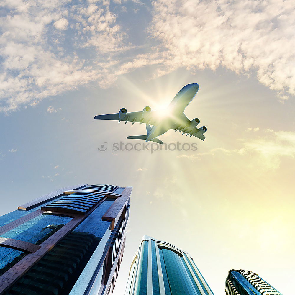 Similar – Plane flying over building