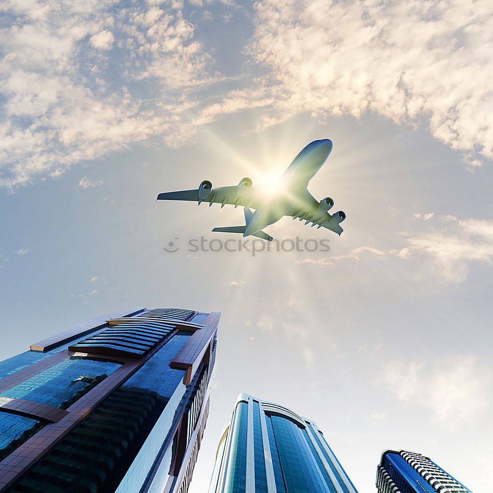 Similar – Plane flying over building