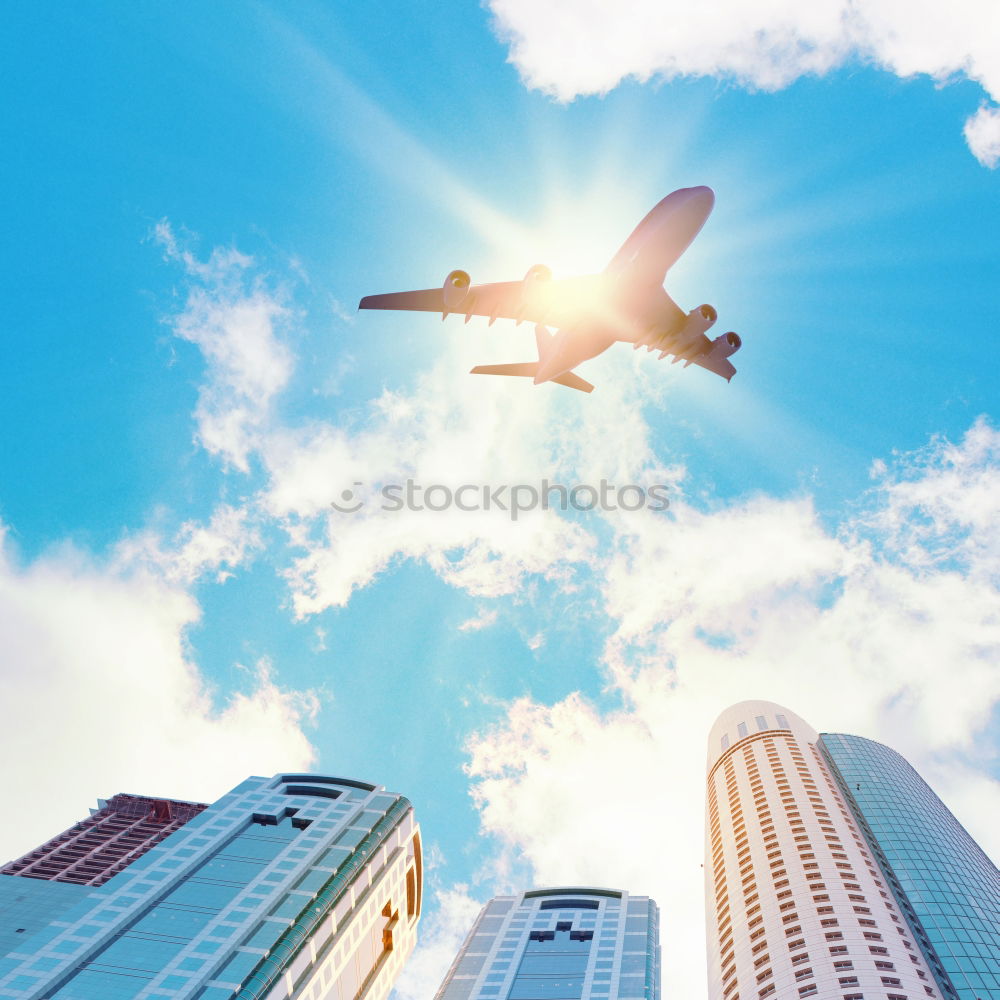 Similar – Plane flying over building