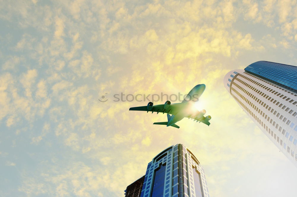 Similar – Plane flying over building