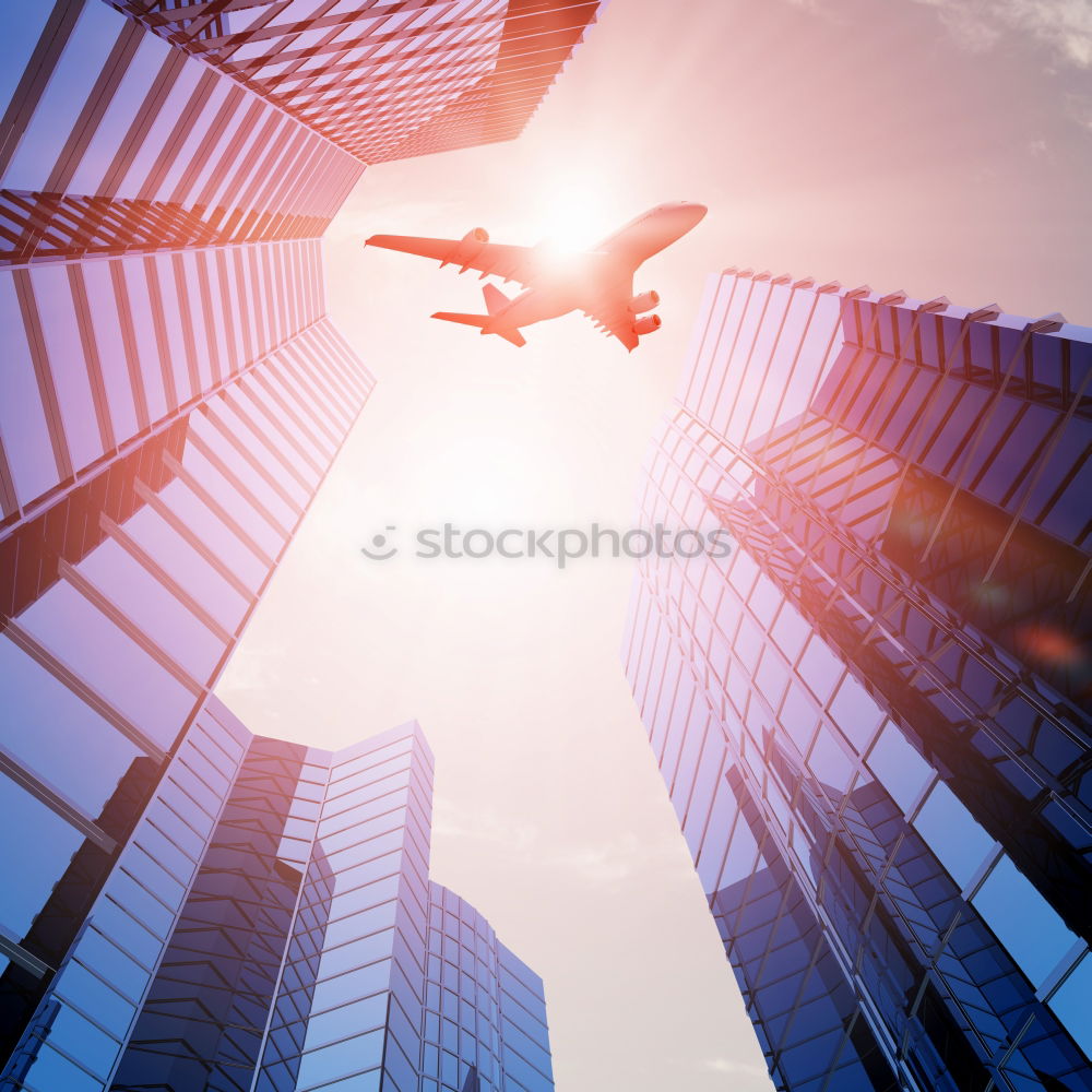 Similar – Plane flying over building