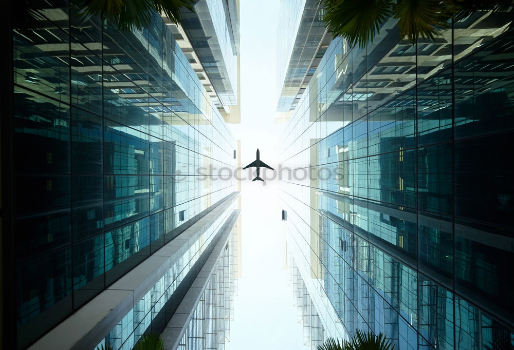 Plane flying over building