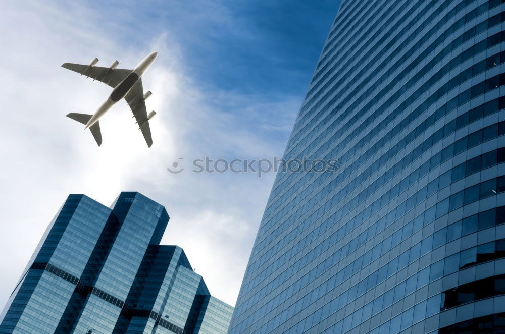 Similar – Plane flying over building