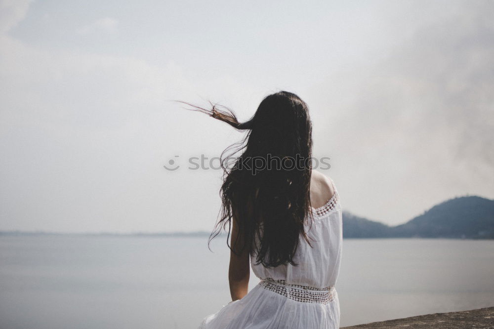 Similar – Blonde white woman moving the hair with the wind.