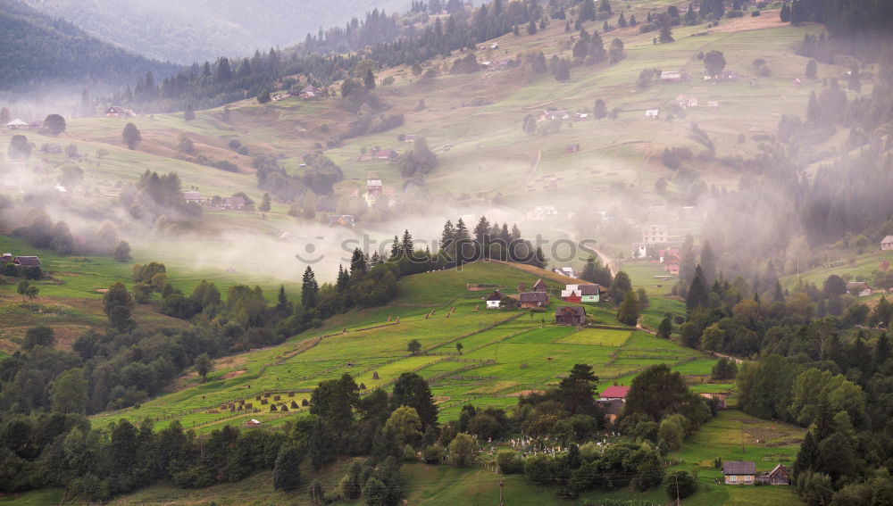 Similar – Alpine village in mountains. Smoke, bonfire and haze