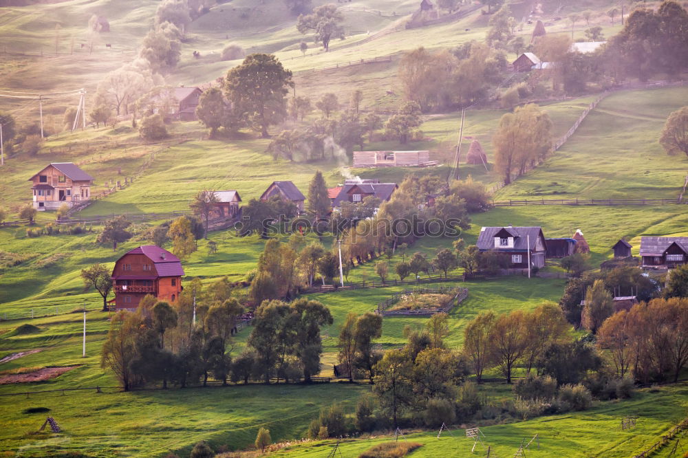 Alpine village in mountains. Smoke and haze