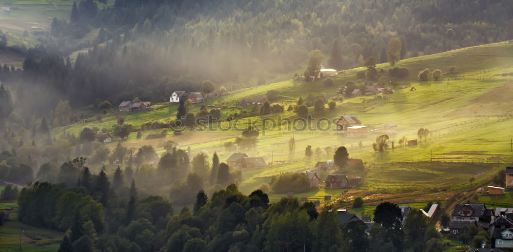 Similar – Alpine village in mountains. Smoke and haze