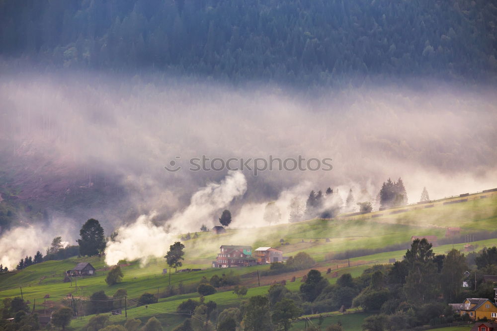 Similar – Alpine village in mountains. Smoke, bonfire and haze