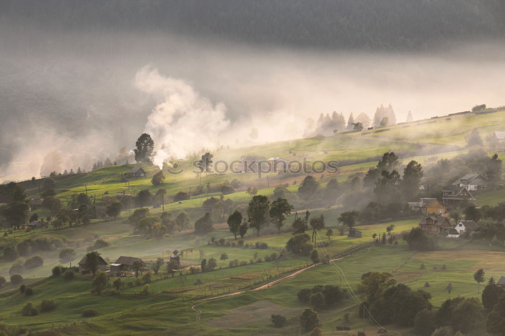 Similar – Alpine village in mountains. Smoke, bonfire and haze