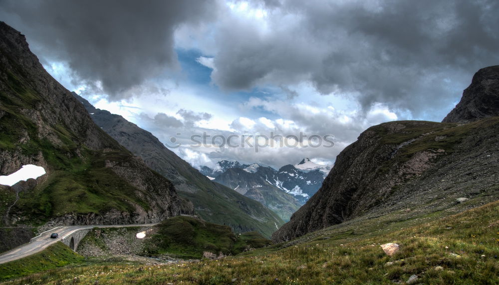 Similar – Pass road winds through green hilly landscape