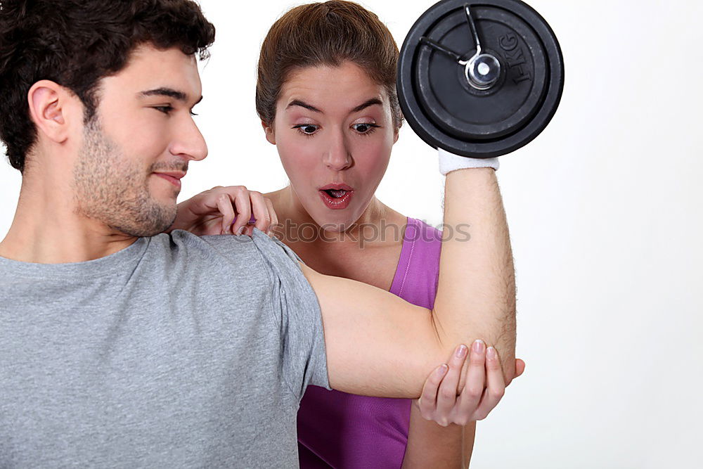 Similar – Female personal trainer helping a young man lift weights