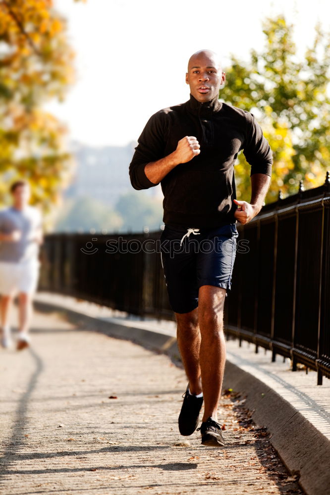 Similar – Black man running and listening to music in urban background