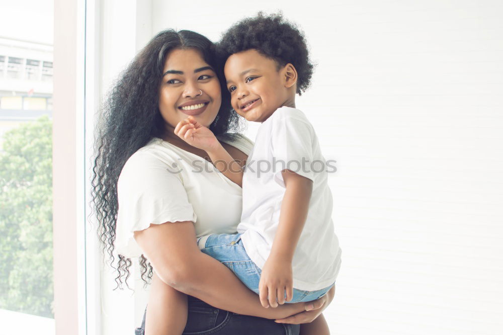 Similar – Image, Stock Photo African american mother giving daughter a kiss on cheek