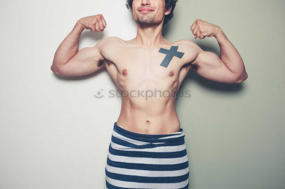 Similar – Image, Stock Photo young man spreads his arms like an angel while leaning against the wall with a tattoo on his bare chest