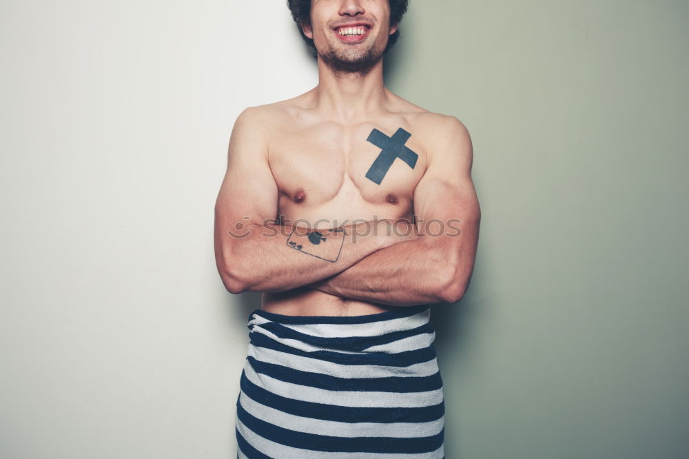 Similar – Image, Stock Photo young man spreads his arms like an angel while leaning against the wall with a tattoo on his bare chest