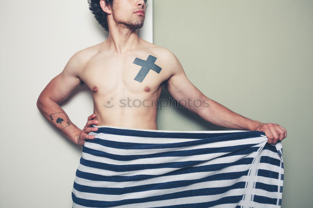 Similar – Image, Stock Photo young man spreads his arms like an angel while leaning against the wall with a tattoo on his bare chest