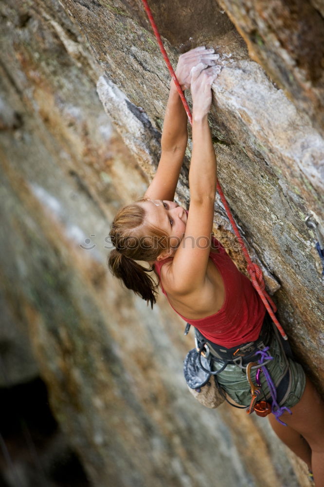 Similar – Young rock climber woman climbing the rock wall