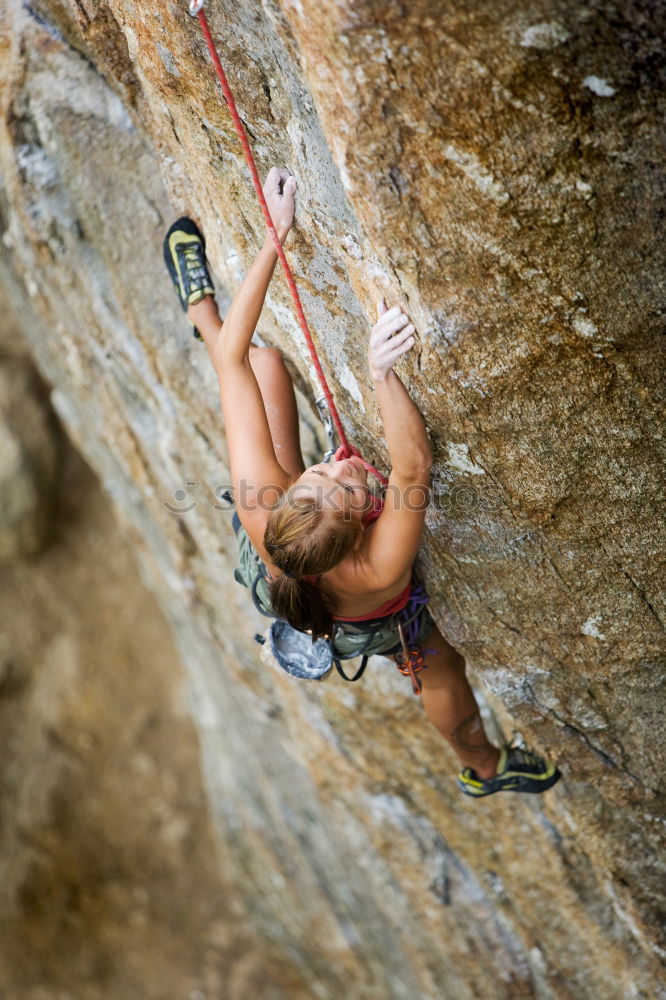 Similar – Female climber clinging to a cliff.