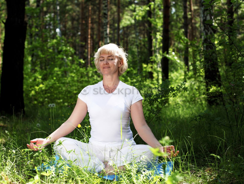 Similar – Young woman meditates in yoga asana Padmasana