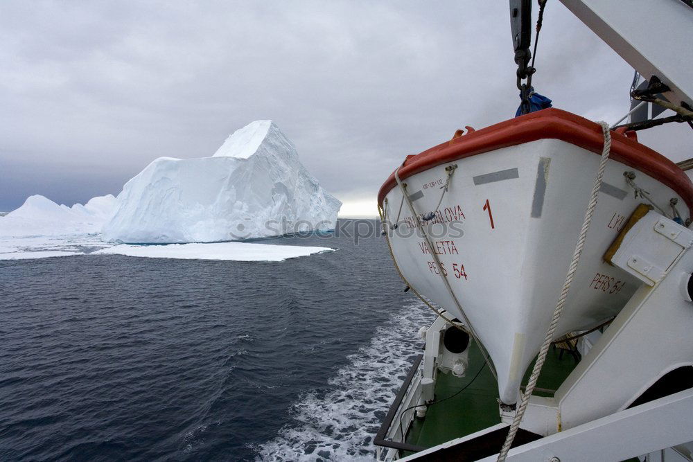 Similar – Snowfall and cruise liner among blue icebergs in Port Charcot