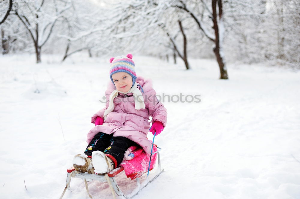 Similar – Teenage girl pulling sled with her little sister through forest