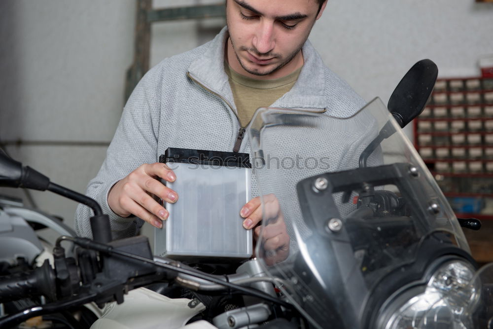 Similar – Image, Stock Photo Mechanic cleaning a motorcycle