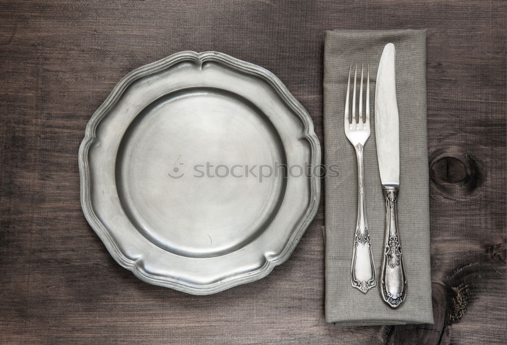 Similar – cutlery on the gray wooden surface