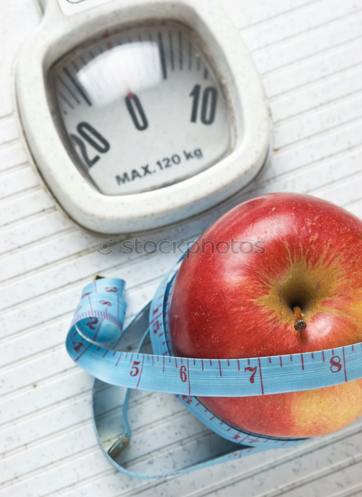 Red apple with a tape measure